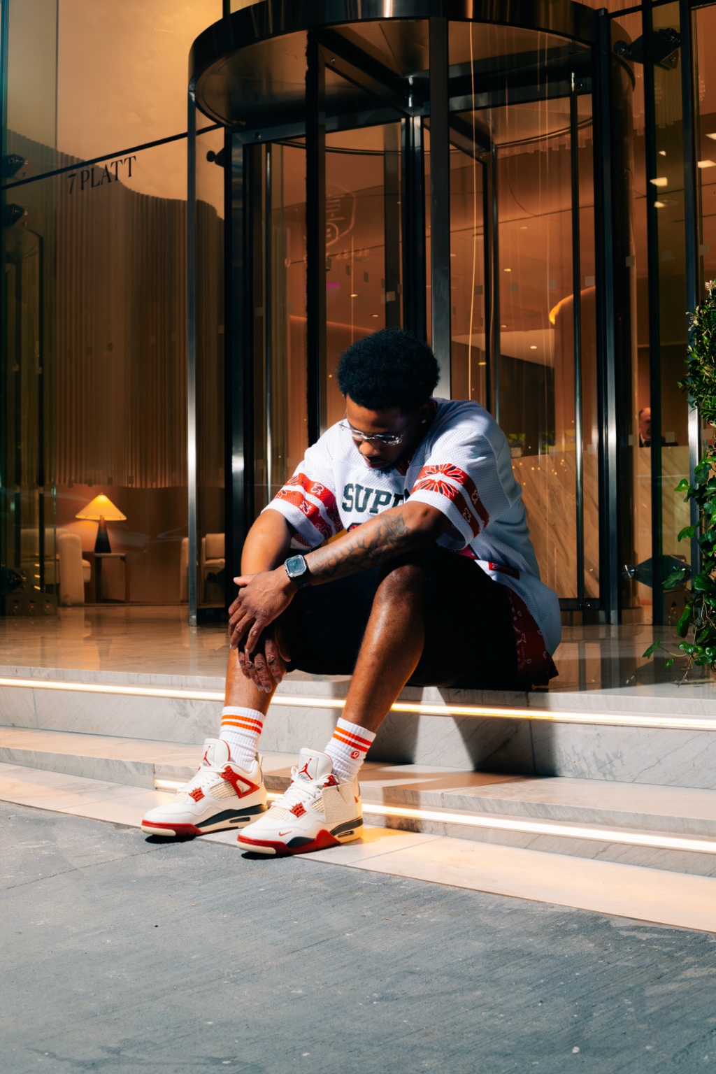 DJ Noellxve seated outside 7 Platt Street in New York
